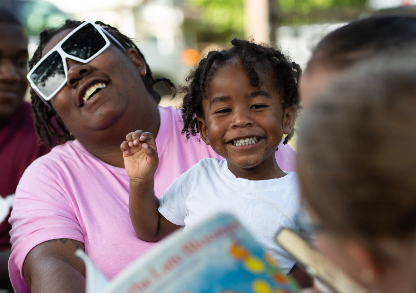 Residents in the Clarksburg, WV enjoy read aloud in their community garden in the Monticello neighborhood